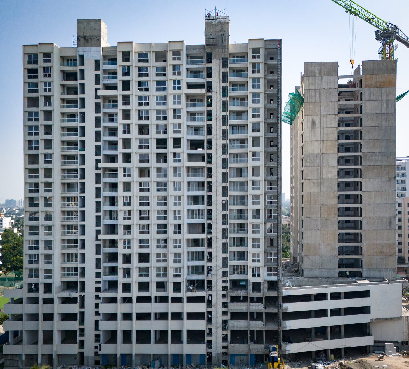 Residential tower construction progress monitoring — drone aerial elevation view with crane, Pune, AerialPhotoIndia