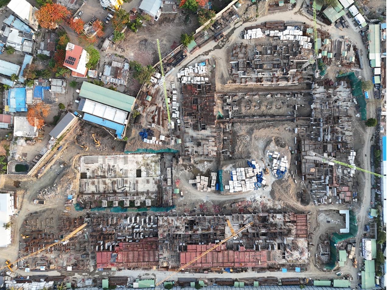 Overhead drone photograph documenting construction progress of large residential development — AerialPhotoIndia