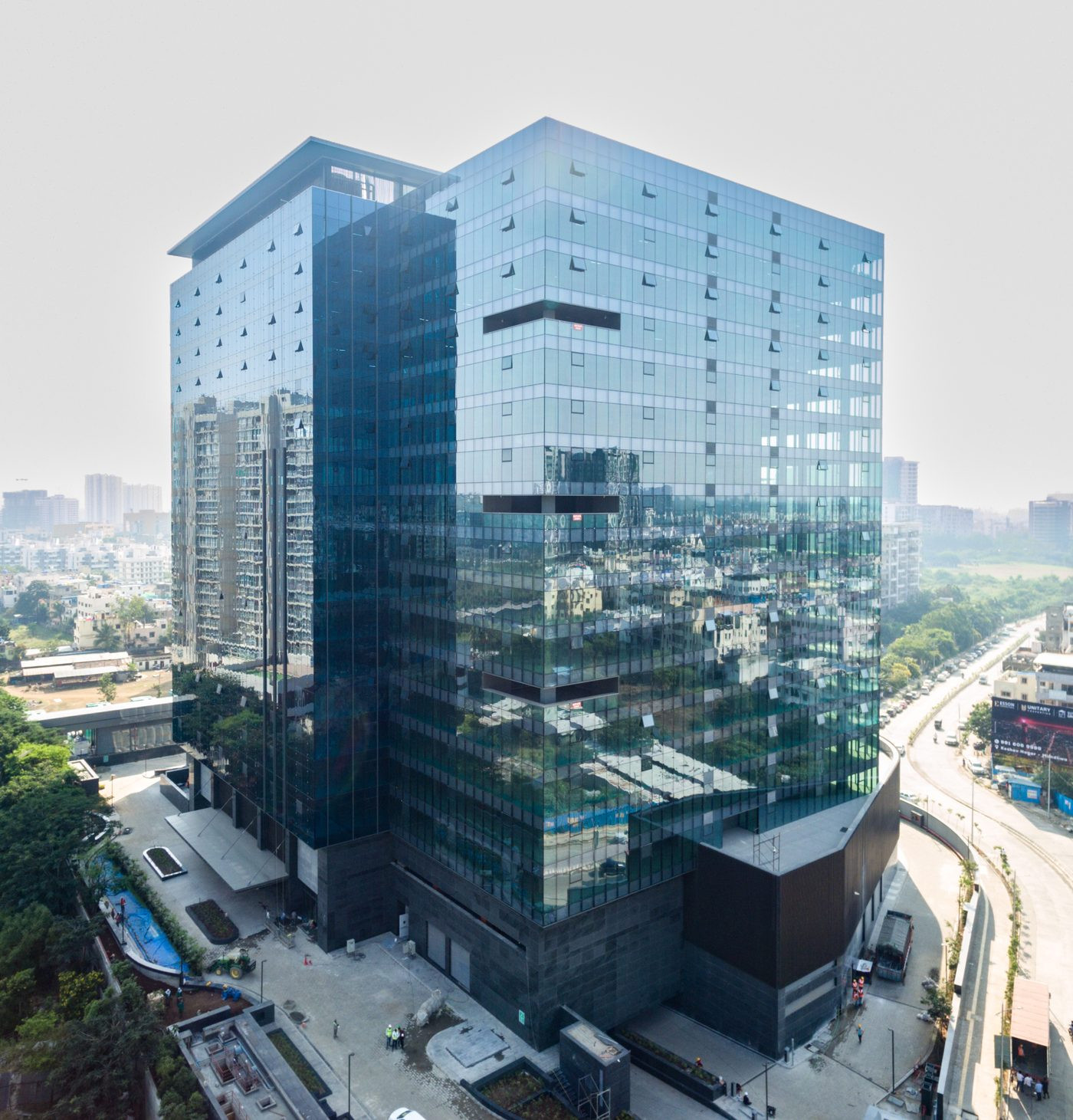 Glass curtain wall building facade — drone thermography combines visual inspection like this with thermal imaging to detect hidden moisture and insulation failure, AerialPhotoIndia Pune