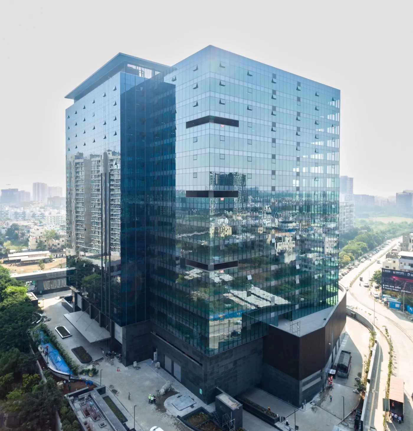 Glass curtain wall building facade — drone thermography combines visual inspection like this with thermal imaging to detect hidden moisture and insulation failure, AerialPhotoIndia Pune