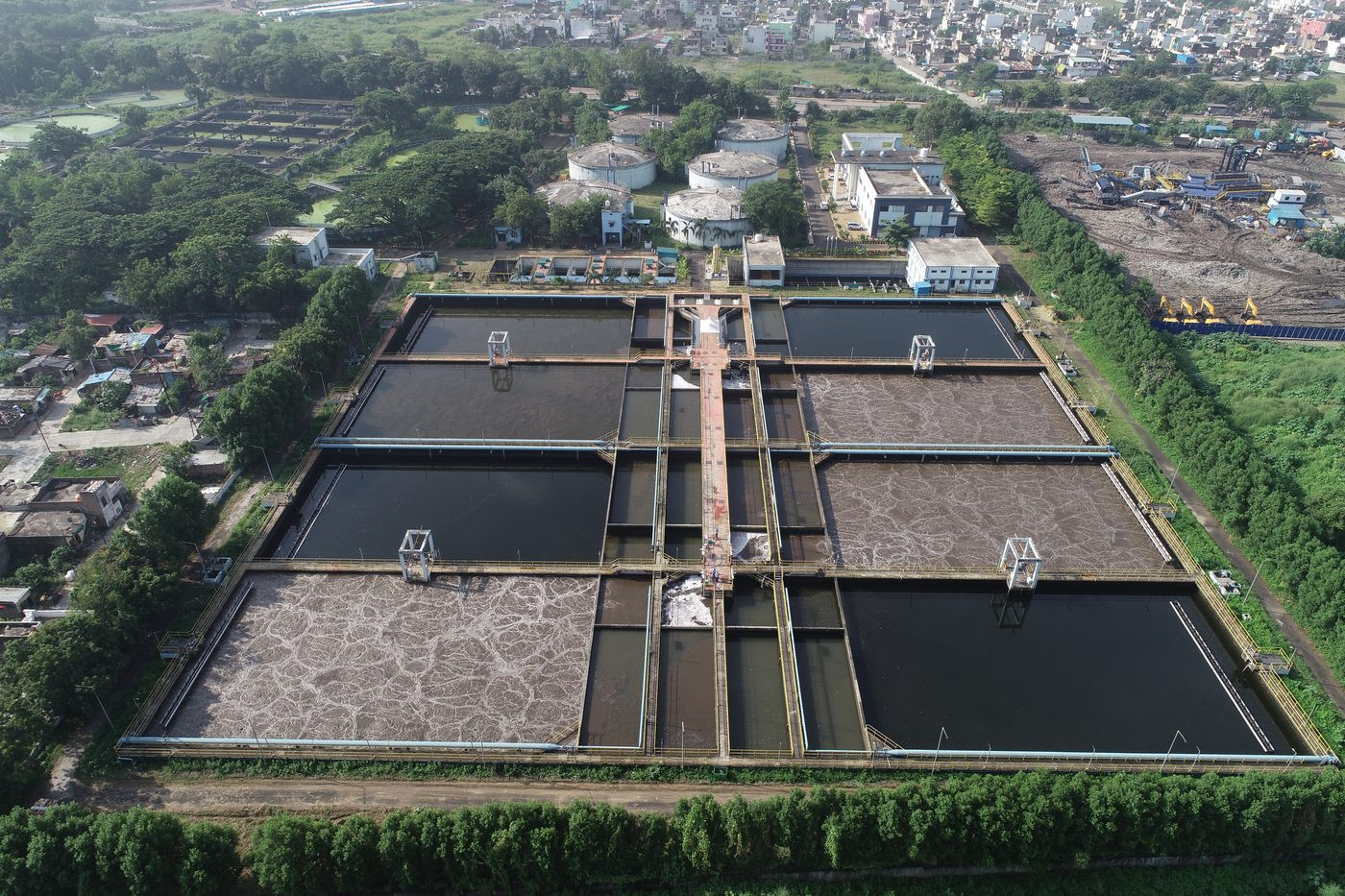 Circular water treatment clarifiers bird's eye aerial drone photography — industrial infrastructure, AerialPhotoIndia